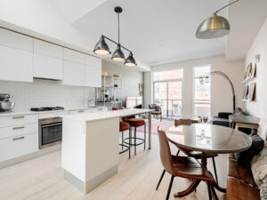 Modern kitchen and dining room with central island and walk-out to balcony | 243 Perth Ave PH307 | the BREL team